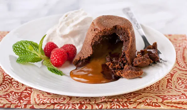 in the kitchen with stefano faita chocolate dulce de leche lava cakes with cinnamon whipped cream and a dusting of icing sugar