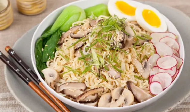 in the kitchen with stefano faita ramen noodle mushroom soup served in a white bowl on a plate with a pair of chopsticks